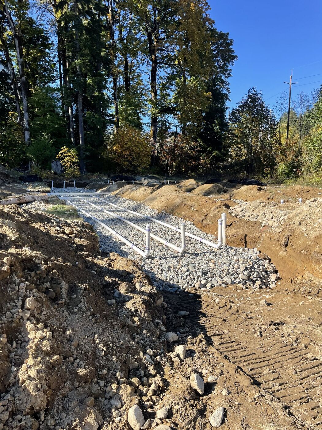 Trenched drain field with risers during construction inspection